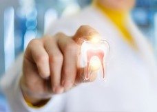 Dentist holding a shining tooth model